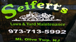 Seifert's Lawn & Yard Maintenance lettering with phone number on a black truck door